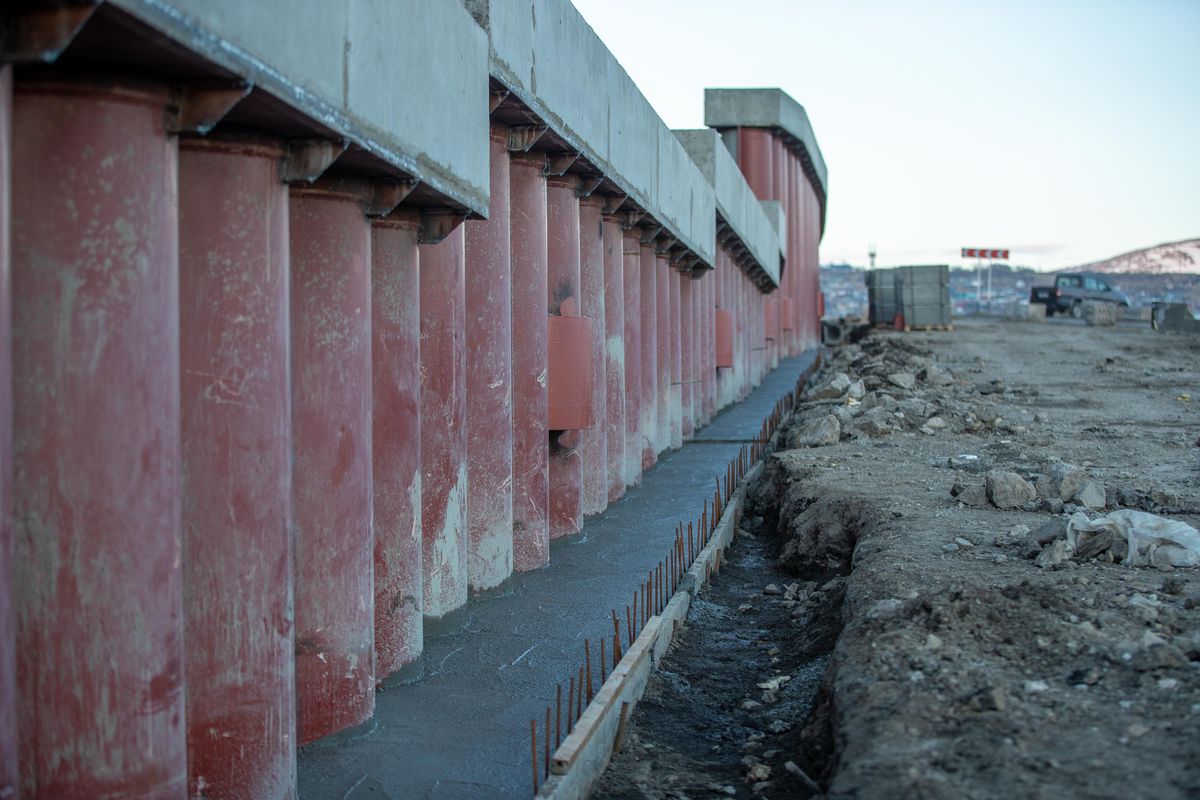 Row of round cylindrical concrete column forms on a construction site