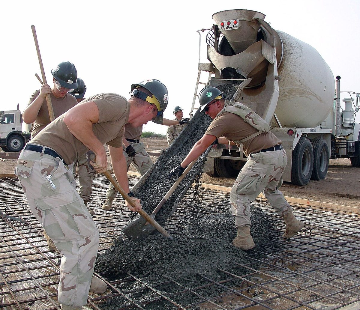 Crew pouring a concrete pad