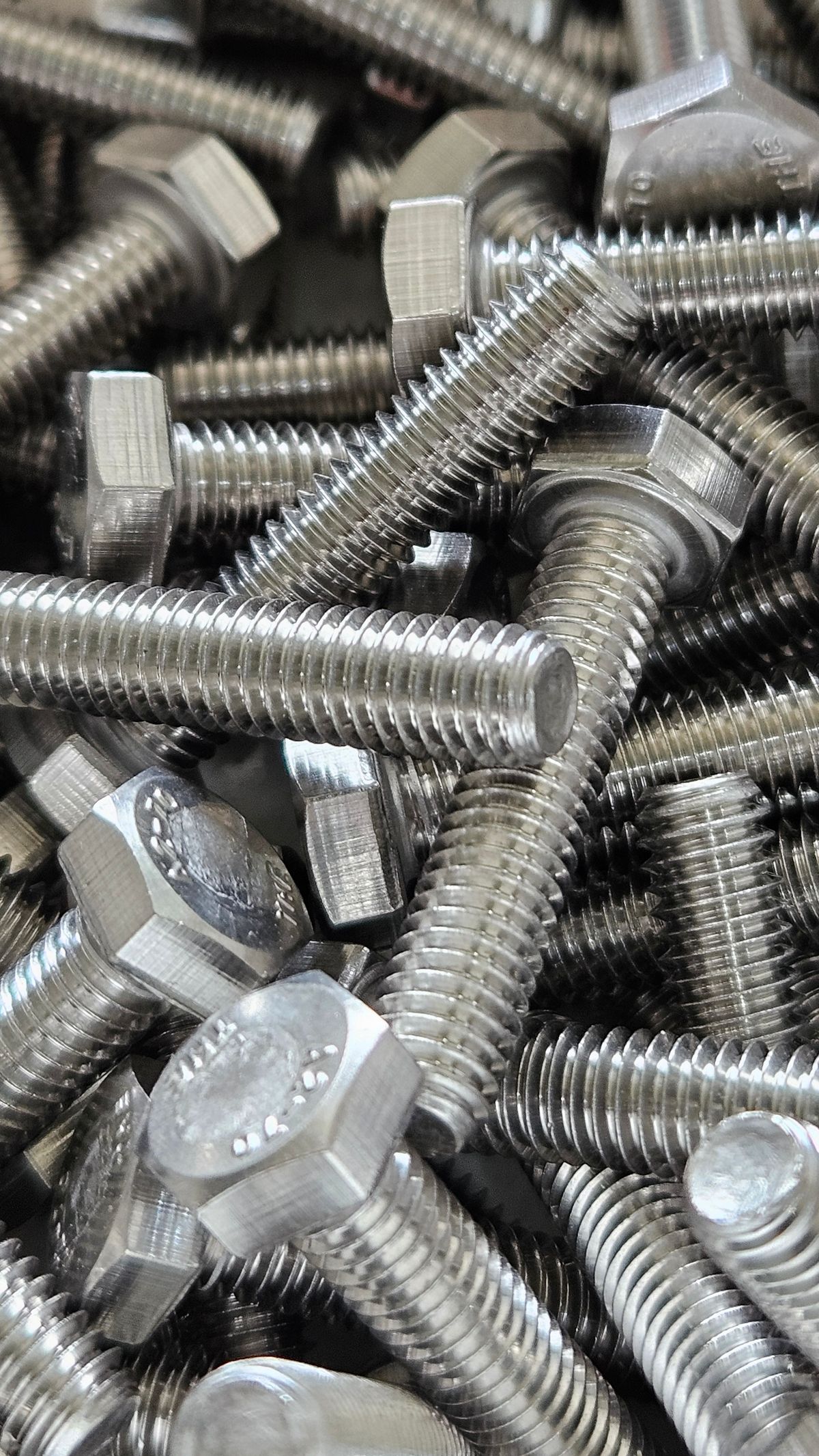 Pile of steel hex-head bolts