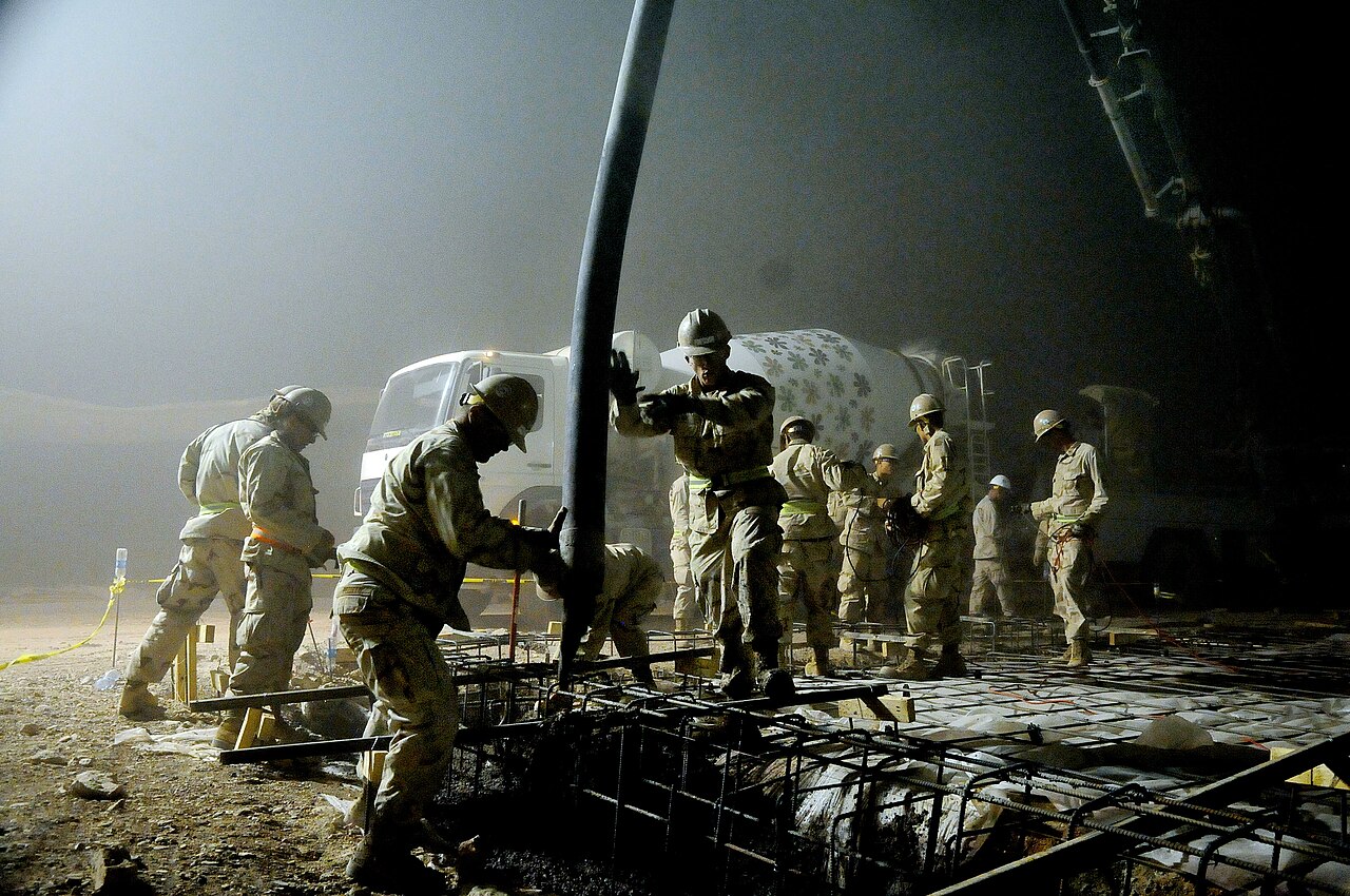 Concrete being poured into a footing form