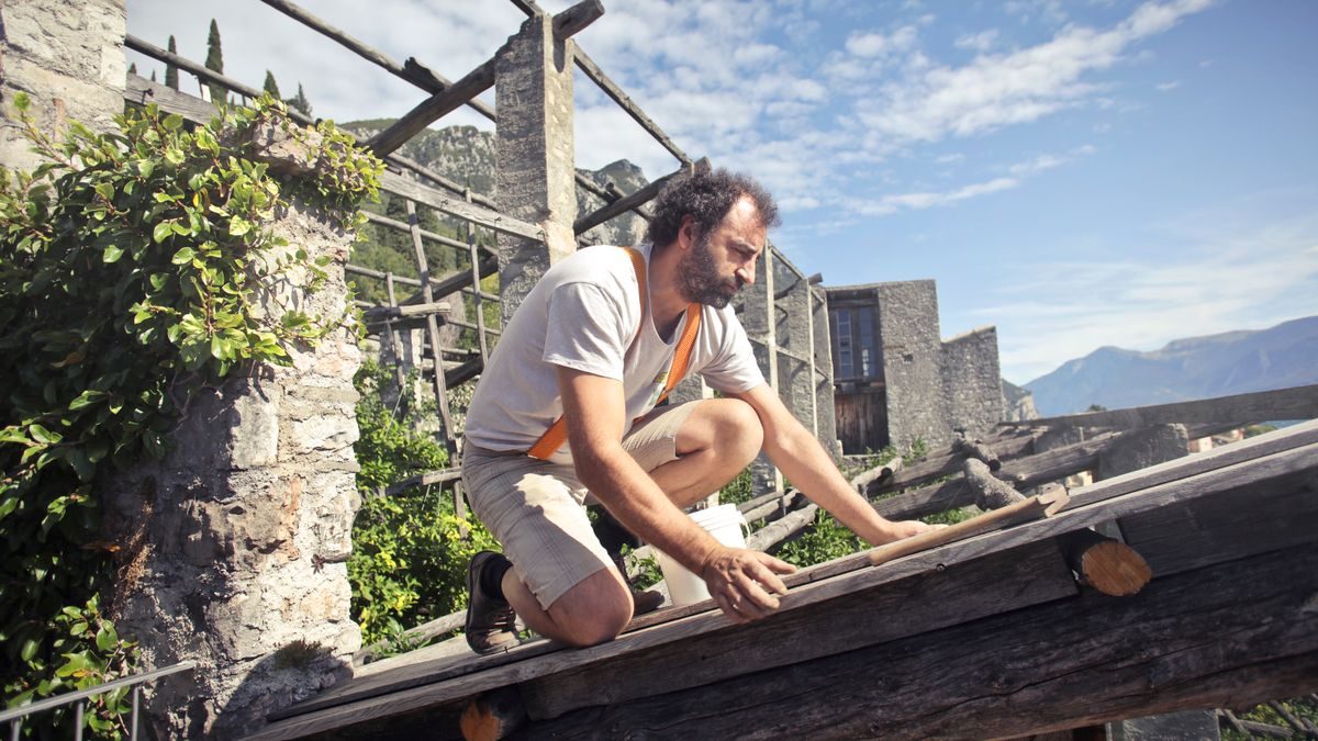Worker building a wooden roof frame