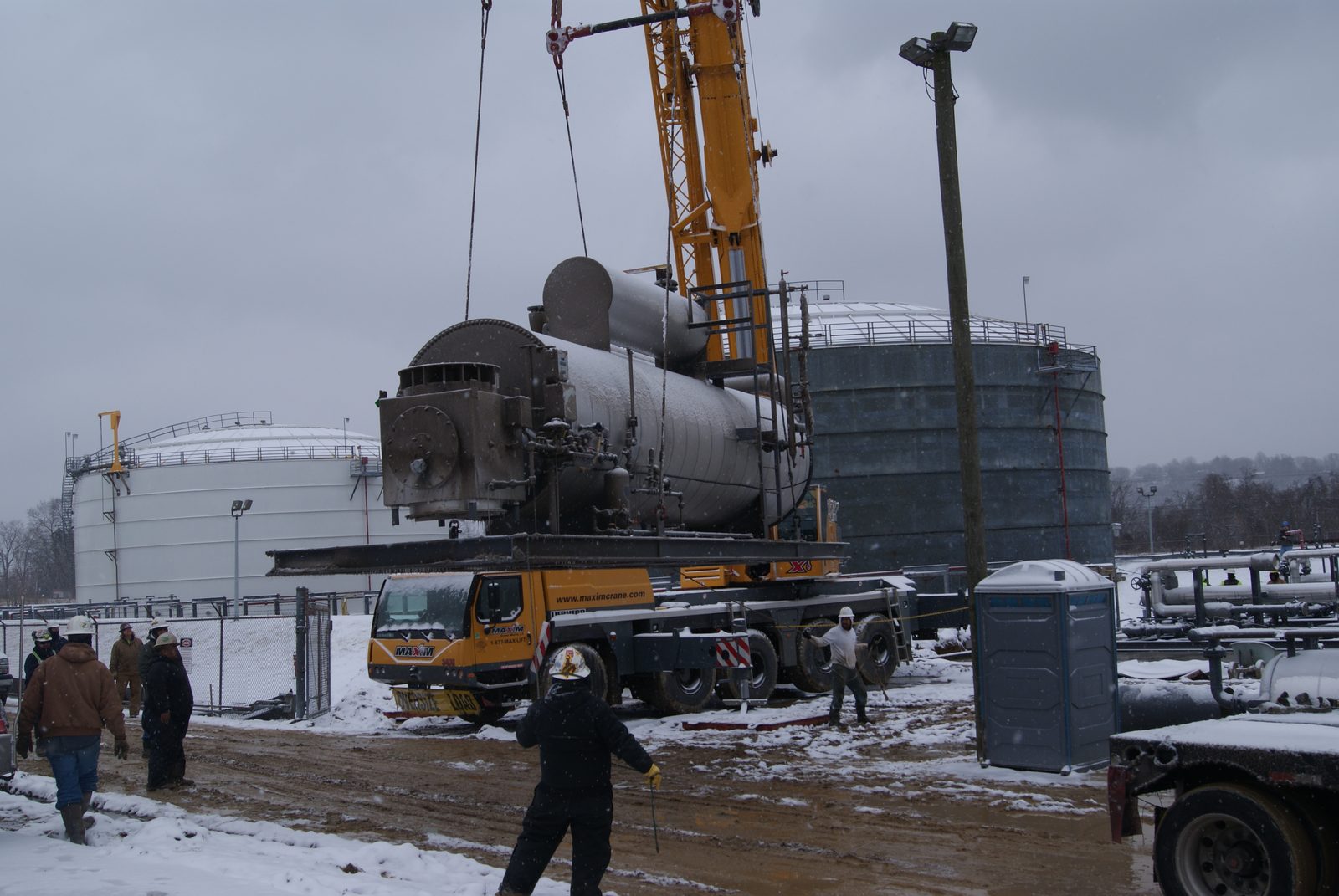 Crane setting process equipment between storage tanks during a terminal build